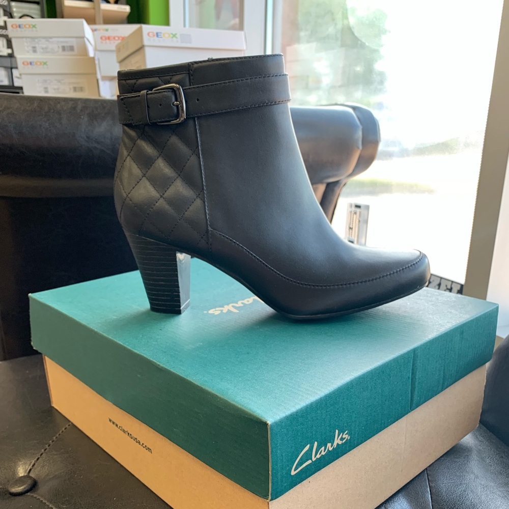 Black leather women’s ankle boot with belt detail